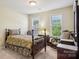 Cozy bedroom with natural light, vintage furniture, and relaxing window views at 10716 Persimmon Creek Dr, Mint Hill, NC 28227