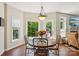 Sunny breakfast nook featuring a round table, views to the landscaped yard, and access to a deck at 10716 Persimmon Creek Dr, Mint Hill, NC 28227