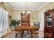 Formal dining room with a chandelier, wood furniture, and elegant décor at 10716 Persimmon Creek Dr, Mint Hill, NC 28227