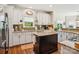 Well-appointed kitchen boasting granite countertops, stainless steel appliances, and an island with black cabinets at 10716 Persimmon Creek Dr, Mint Hill, NC 28227