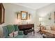 Cozy living room showcasing an antique piano, green armchair, and decorative accents at 10716 Persimmon Creek Dr, Mint Hill, NC 28227