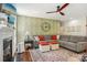 Comfortable living room features an accent wall, a ceiling fan, and an area rug at 10716 Persimmon Creek Dr, Mint Hill, NC 28227