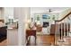 Inviting living room view featuring hardwood floors, fireplace, and seamless open-concept design to the kitchen area at 10716 Persimmon Creek Dr, Mint Hill, NC 28227