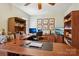 Professional office space with plenty of desk space, shelving, and natural light at 10716 Persimmon Creek Dr, Mint Hill, NC 28227