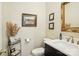 Charming powder room features elegant vanity, marble countertop, and stylish decor at 10716 Persimmon Creek Dr, Mint Hill, NC 28227