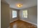 This bedroom features hardwood flooring, neutral colored walls, and natural light from the windows at 119 N Laurel Ave # 1, Charlotte, NC 28207