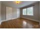 Comfortable bedroom with hardwood floors, neutral walls, and natural light at 119 N Laurel Ave # 1, Charlotte, NC 28207