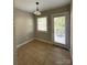 This dining area features tile flooring, a modern light fixture and a door with backyard access at 119 N Laurel Ave # 1, Charlotte, NC 28207