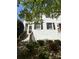 White brick home with dark shutters, surrounded by greenery and a brick staircase at 119 N Laurel Ave # 1, Charlotte, NC 28207