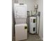 The utilitarian space features a washer, dryer and hot water tank at 119 N Laurel Ave # 1, Charlotte, NC 28207