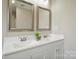 Bathroom featuring a double sink vanity with modern faucets and decorative mirrors at 125 Rocky Pt, Cleveland, NC 27013