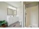 Bathroom featuring a double sink vanity, walk-in shower, and modern fixtures at 125 Rocky Pt, Cleveland, NC 27013