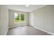 This bedroom features neutral walls, modern gray flooring, and a scenic window view at 125 Rocky Pt, Cleveland, NC 27013