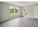 Bedroom with neutral walls, modern gray flooring, and a view to the adjacent bathroom at 125 Rocky Pt, Cleveland, NC 27013