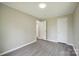Bedroom features neutral walls and modern gray flooring with a closet and open doorway at 125 Rocky Pt, Cleveland, NC 27013