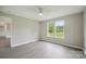 Bedroom featuring neutral walls, modern gray flooring, and large windows with a scenic view at 125 Rocky Pt, Cleveland, NC 27013