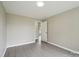 This bedroom offers neutral walls, modern gray flooring, and an entrance to the bathroom at 125 Rocky Pt, Cleveland, NC 27013