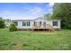 Inviting single-story home with a front deck and well-manicured lawn at 125 Rocky Pt, Cleveland, NC 27013