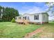 A cozy single-story home featuring a wooden front deck and a spacious yard at 125 Rocky Pt, Cleveland, NC 27013