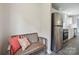 Cozy hallway with a bench, pillows, and stainless steel refrigerator leading to the kitchen at 125 Rocky Pt, Cleveland, NC 27013