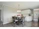 Eat-in kitchen featuring white cabinets, stainless steel appliances, and a round dining table at 125 Rocky Pt, Cleveland, NC 27013