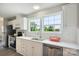 Bright and modern kitchen features white cabinets, stainless steel appliances, and a large window at 125 Rocky Pt, Cleveland, NC 27013