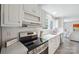 Bright kitchen with white cabinets, stainless steel appliances, and a window overlooking the backyard at 125 Rocky Pt, Cleveland, NC 27013