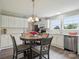 Eat-in kitchen featuring white cabinets, stainless steel appliances, and a round dining table at 125 Rocky Pt, Cleveland, NC 27013