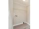 This laundry area features light gray walls, wooden floors and a shelf for storage at 125 Rocky Pt, Cleveland, NC 27013