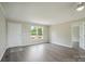Bright living room features gray wood floors, neutral paint, and double window for natural light at 125 Rocky Pt, Cleveland, NC 27013