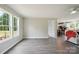Spacious living room with wood-look floors featuring lots of natural light, and access to other rooms at 125 Rocky Pt, Cleveland, NC 27013