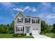 Charming two-story home with gray siding, dark shutters, and an attached one-car garage at 128 Millstream Dr, China Grove, NC 28023