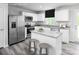 Bright kitchen featuring white cabinetry, stainless steel appliances, and granite countertops with a center island at 128 Millstream Dr, China Grove, NC 28023