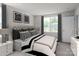 Serene bedroom with a tufted headboard bed, neutral decor, and natural light from a large window at 128 Millstream Dr, China Grove, NC 28023