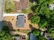 Overhead view of a house showcasing the roof, driveway, and surrounding yard with mature trees at 1306 Klondale Ave, Kannapolis, NC 28081