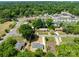 An aerial view of the home showcasing the neighborhood surroundings with mature trees and nearby homes at 1306 Klondale Ave, Kannapolis, NC 28081