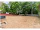 Large, freshly seeded backyard with privacy fence and mature trees, perfect for outdoor activities at 1306 Klondale Ave, Kannapolis, NC 28081