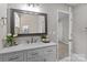Light-filled bathroom with marble countertop vanity and decorative mirror at 1306 Klondale Ave, Kannapolis, NC 28081
