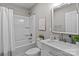 Bright bathroom with a shower and tub combination, white marble vanity, and decorative touches at 1306 Klondale Ave, Kannapolis, NC 28081