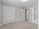 Neutral bedroom featuring carpet floors and multiple closets/doorways for easy access at 1306 Klondale Ave, Kannapolis, NC 28081