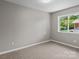Small bedroom illuminated by natural light streaming through a window at 1306 Klondale Ave, Kannapolis, NC 28081