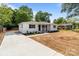 Charming single-story home featuring a fresh concrete driveway and inviting front yard landscaping at 1306 Klondale Ave, Kannapolis, NC 28081