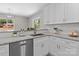 Close-up of updated kitchen countertops, sink, faucet, and stainless steel dishwasher at 1306 Klondale Ave, Kannapolis, NC 28081