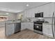 Updated kitchen showcasing stainless steel appliances, white cabinets, granite countertops and natural lighting at 1306 Klondale Ave, Kannapolis, NC 28081