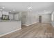 Open floor plan from the kitchen to the living room with updated stainless steel appliances and bar seating at 1306 Klondale Ave, Kannapolis, NC 28081