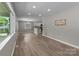 Open floor plan with the living room flowing into kitchen with natural light and light wood-look flooring at 1306 Klondale Ave, Kannapolis, NC 28081