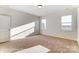 Bedroom featuring a door and two windows which offer ample sunlight and neutral carpet at 1436 Ardmore Dr # 342, Sherrills Ford, NC 28673