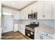 Well-lit kitchen boasts stainless steel appliances and sleek, white cabinetry at 1436 Ardmore Dr # 342, Sherrills Ford, NC 28673