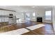 Bright open concept featuring modern kitchen with island, a fireplace, and sliding doors to the backyard at 1436 Ardmore Dr # 342, Sherrills Ford, NC 28673
