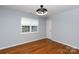 Bright bedroom features hardwood floors, modern lighting, and a window with natural light at 1455 Fieldcrest Cir, Rock Hill, SC 29732